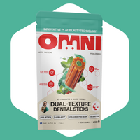 Packaging of Omni Dual-Texture Dental Sticks on a green background