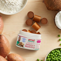 Open jar of Omni Rescue Joints & Mobility supplement on a wooden surface with onions, peas, and coconuts.