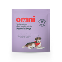 Purple package of 'omni' dog treats for peaceful dogs on a white background