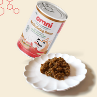 Can of Omni pet food with a sample on a white plate against a beige background