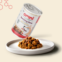 Can of Omni Soothing Stew with a scoop of the stew on a plate against a beige background