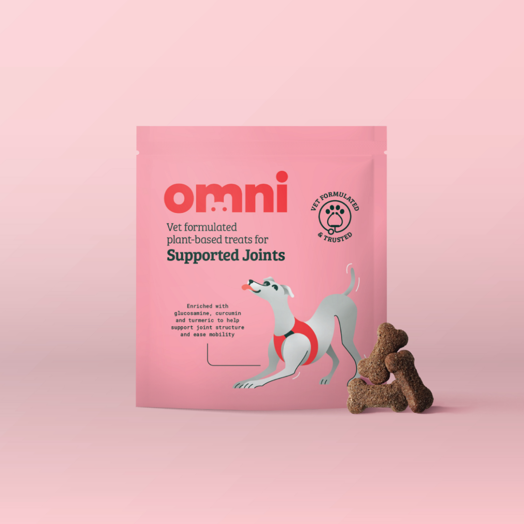 Pink package of 'omni' dog treats for supported joints on a pink background